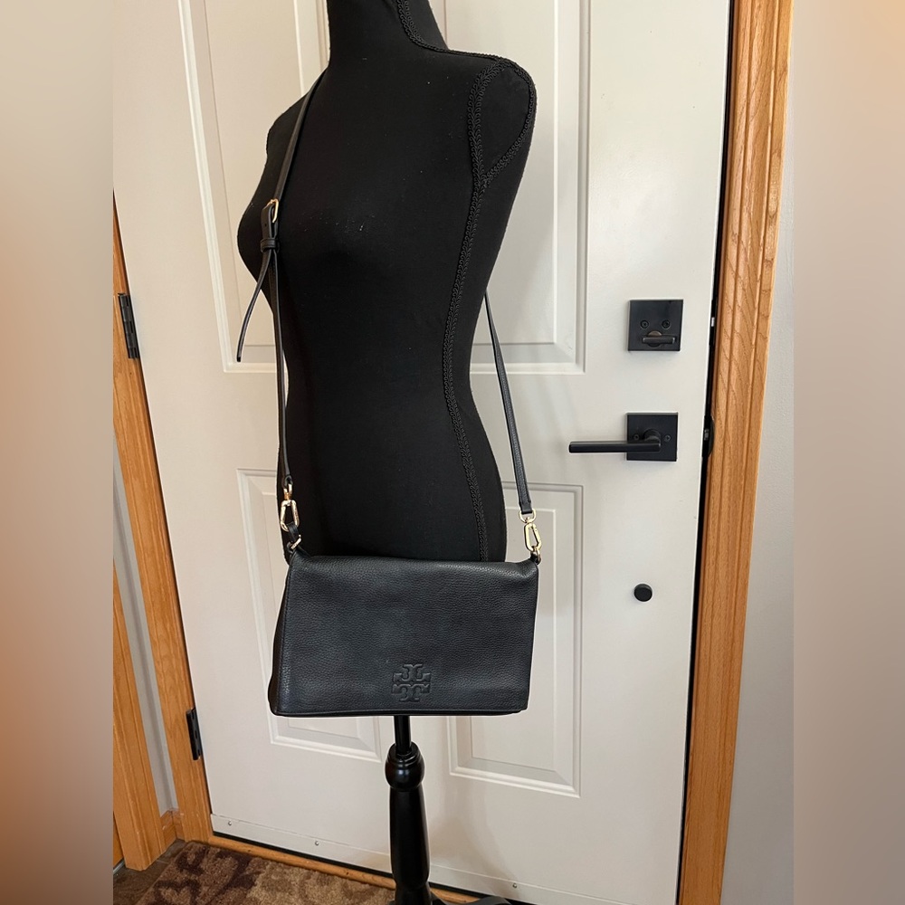 Tory Burch black pebbled leather fold over embossed logo crossbody clutch purse.
